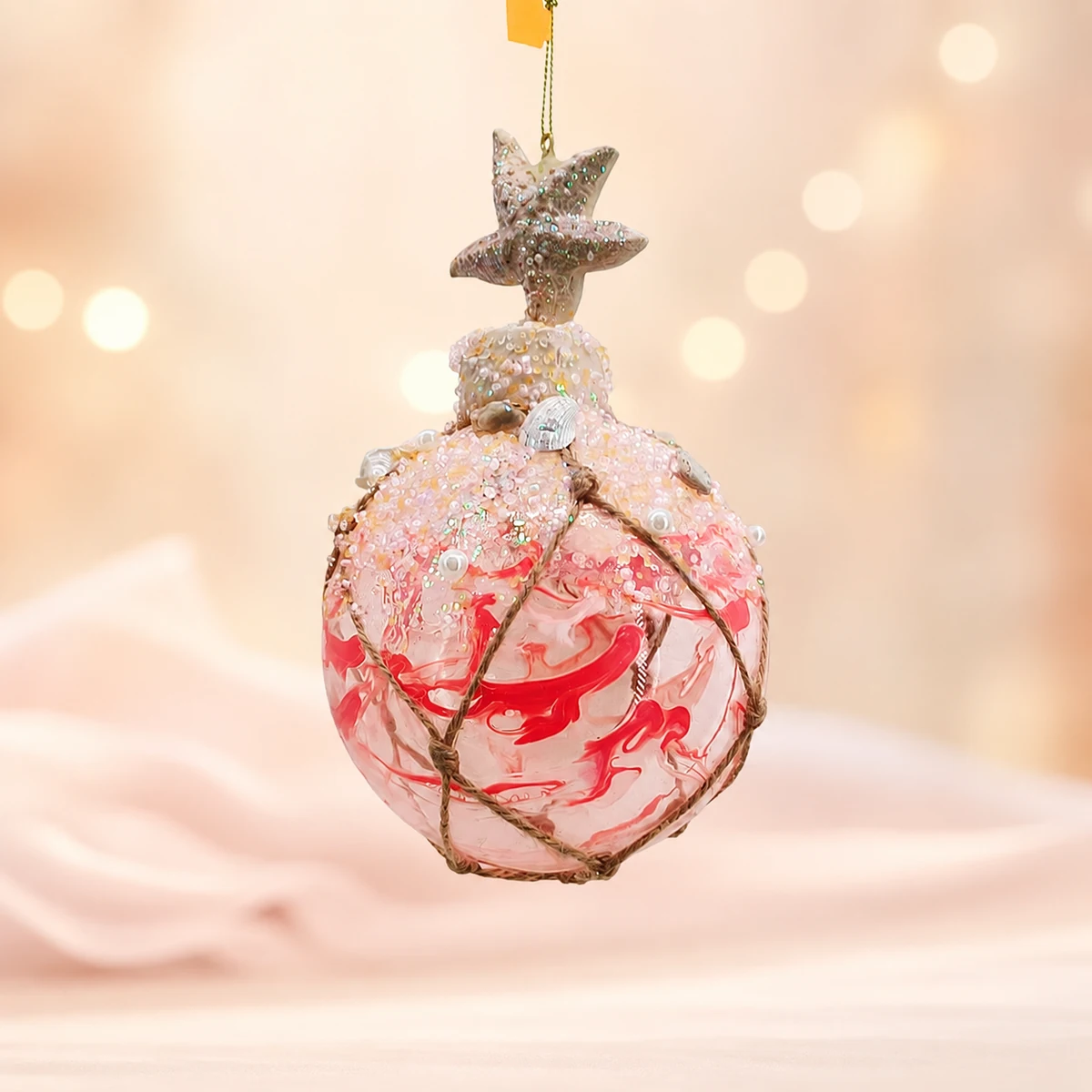 Glass floral ball ornament with star top display