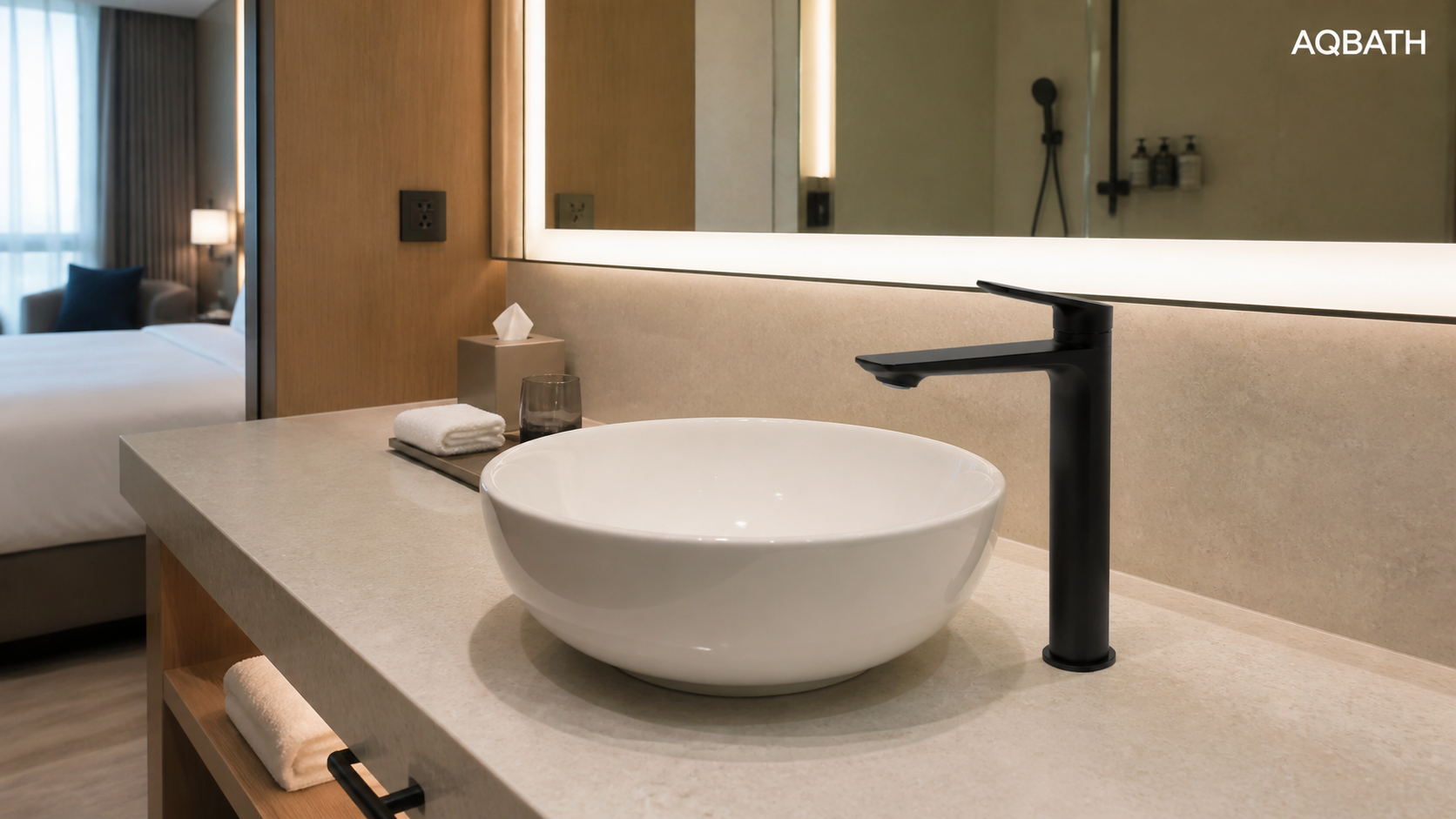 Tall matte-black AQBATH basin faucet installed at a hotel guest-room vanity